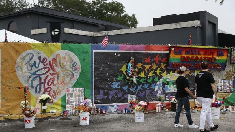People visit the memorial to the victims of the mass shooting set up around the Pulse  nightclub in  Orlando, Florida, nightclub.