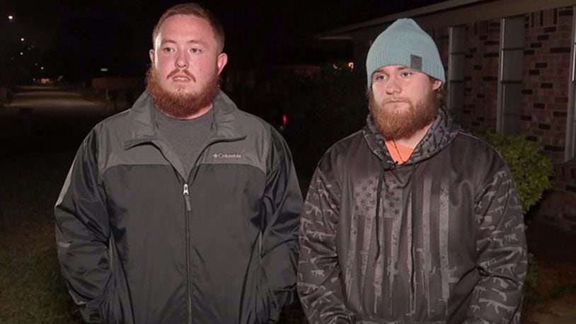 Brandon Denmark (left) and Jared Whitcher (right) helped lift a truck off of a woman who was pinned beneath the vehicle.
