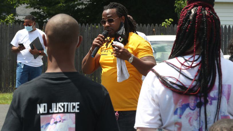 Dion Green, organizer of the "No More Silence, End Gun Violence" rally and march, speaks during the event Saturday. BILL LACKEY