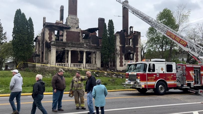 Dayton Fire Department staff, city of Dayton officials and representatives of Preservation Dayton discuss the Traxler Mansion fire at the corner of Broadway and Yale in West Dayton on Sunday, April 23, 2023. JEREMY P. KELLEY / STAFF