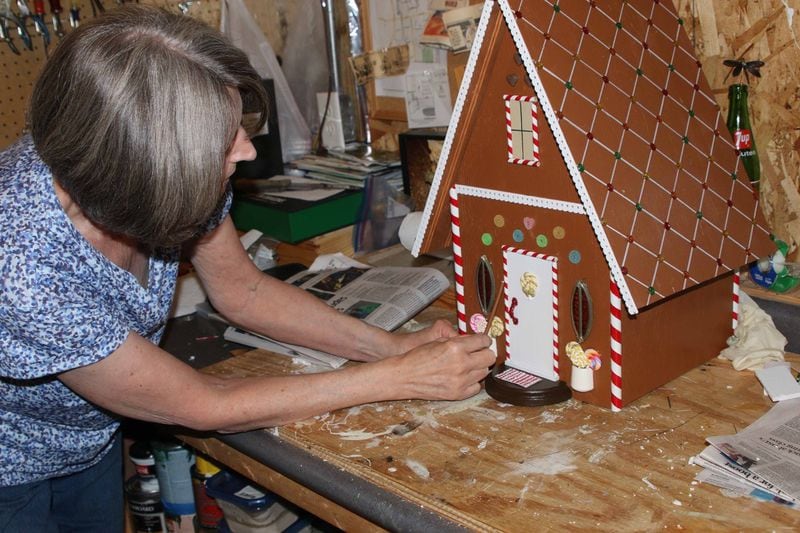 Kathy Anderson works on her gingerbread house. CONTRIBUTED/DAVID ANDERSON