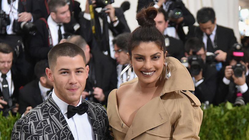Nick Jonas (L) and Priyanka Chopra are engaged after two months of dating, according to a report.  (Photo by Mike Coppola/Getty Images for People.com)