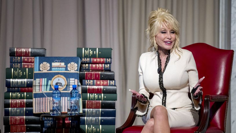 In this photo from 2018, Singer-songwriter Dolly Parton speaks at an event where her organization, Imagination Library, donates the 100 millionth book, Dolly Parton's "Coat of Many Colors," to the Library of Congress collection, Tuesday, Feb. 27, 2018 in Washington. The Library of Congress and Imagination Library also announce a story time for children on the last Friday of each month in the Great Hall of the Thomas Jefferson Building from March through August. (AP Photo/Andrew Harnik)