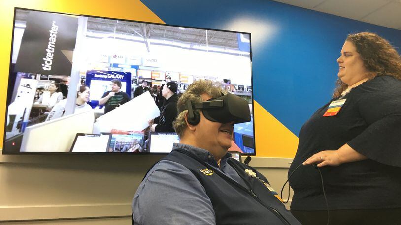 Walmart uses Virtual Reality to train managers at its Training Academy in West Chester. Rachel Hucks directs John Philippo through a training exercise about handling high-stress situations during busy shopping holidays like Black Friday. STAFF PHOTO / HOLLY SHIVELY