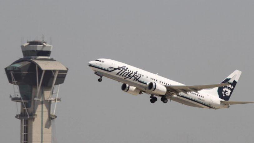 A woman claimed she was racially profiled when she was escorted off an Alaska Airlines flight.