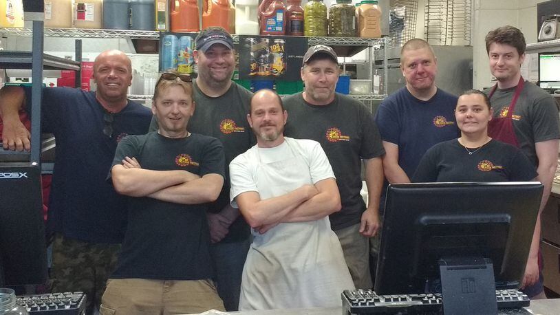 Staff members of Dayton's Original Pizza Factory, including, from left to right: Brian Pilgrim, Rick Pierce, John Sullivan, Justin Barkley, Bill Daniels, Dan Azbill, Angie Elzey, and Daniel Hughes. CONTRIBUTED