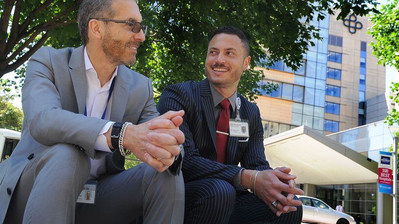 Dr. Marc Belcastro, Premier Chief Medical Officer, left, and his son, Marc II, who is a Premier Advanced Practice Recruiter, talk about why this Father's Day is extra special this year. MARSHALL GORBY\STAFF