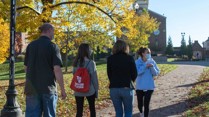 A UD students leads a family on a campus tour. CONTRIBUTED