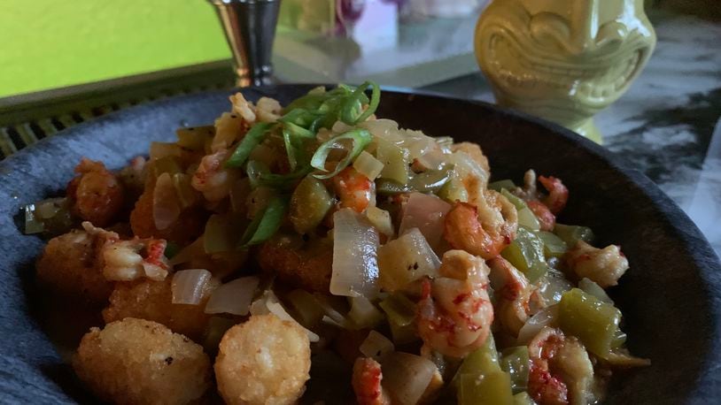 Crawfish Etoufée served over Tiki Tots ($16.95) at Backwater Voodoo in Miamisburg. CONTRIBUTED/ALEXIS LARSEN