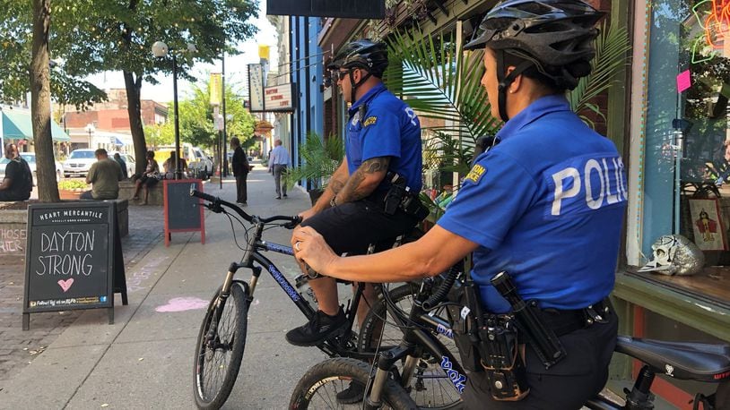 Dayton police officers Kim Pittl (forefront) and Jamie Moebius said they normally patrol the Oregon District and the surrounding areas. This week they said there have been extra officers in the area and they have mainly been patrolling East Fifth Street. BONNIE MEIBERS/STAFF