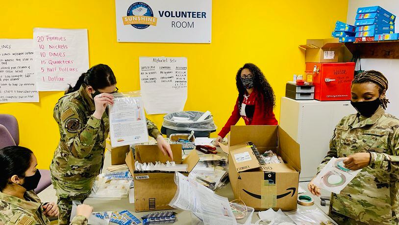 Volunteers from the National Air and Space Intelligence Center on Wright-Patterson Air Force Base organize school supplies on Feb. 26 at Crayons to Classrooms. Crayons to Classrooms helps provide free educational supplies for teachers. CONTRIBUTED PHOTO