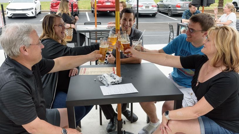 Patrons enjoy the new Warped Wing Brewery & Smokery, located at 6602 Executive Boulevard in Huber Heights next to the Rose Music Center at The Heights. TOM GILLIAM / CONTRIBUTING PHOTOGRAPHER