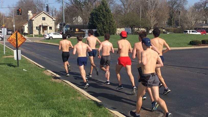 University of Dayton track and field athletes take a shirtless run near campus in 75-degree temperatures on Thursday, April 12, 2018. JEREMY P. KELLEY / STAFF