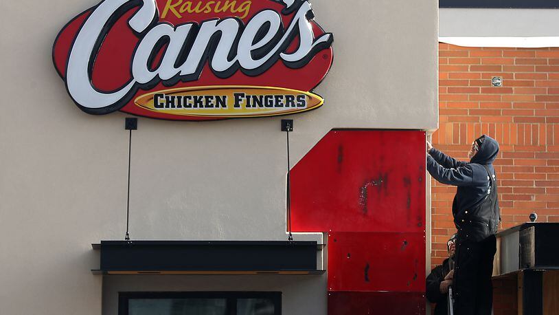 A man works on construction at Raising Cane's Chicken Fingers in January. The restaurant will open on Feb. 15. BILL LACKEY/STAFF