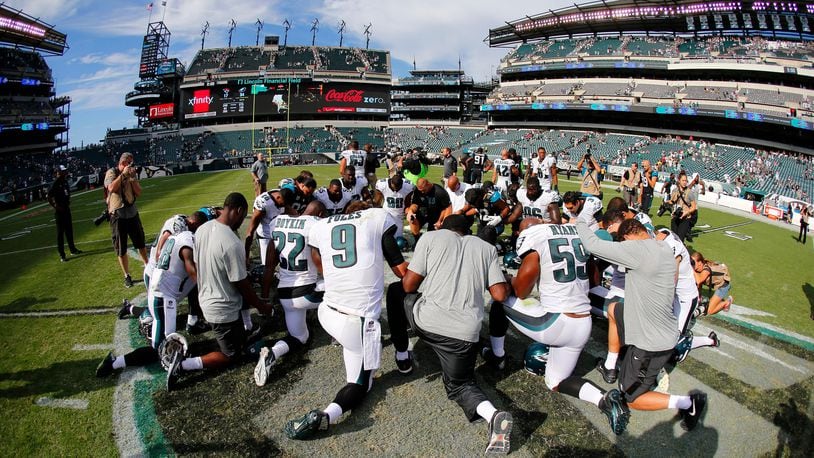 Players from the Philadelphia Eagles and Jacksonville Jaguars kneel for prayer at the 50-yard line after the Eagles defeated the Jaguars 34-17 during a game at Lincoln Financial Field on September 7, 2014 in Philadelphia, Pennsylvania.