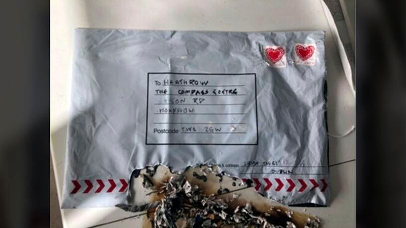 In this handout photo provided by Sky News, a suspect package that was sent to Heathrow airport and caught fire is seen in England, Tuesday, March 5, 2019. Britain's counter-terrorism police are investigating after three suspicious packages were found in London, including one near City Airport and one near Heathrow Airport. Police said Tuesday all three write postal bags contained yellow bags thought by specialist police to be small improvised explosive devices. Police say the devices appear "capable of igniting an initially small fire when opened." (Sky News via AP)