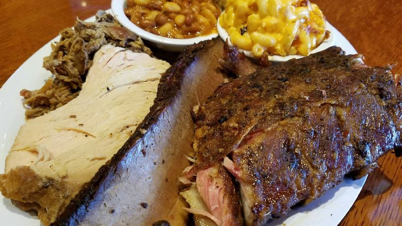 The  four-meats combo dinner at Company 7 BBQ in Englewood. Options include pork, brisket, sausage, turkey, rib meat, chicken or meatloaf.  The four-meat meal is $25.   There is a $2 up charge for each rib meat. Photo: Will Grilliot/Company 7 BBQ