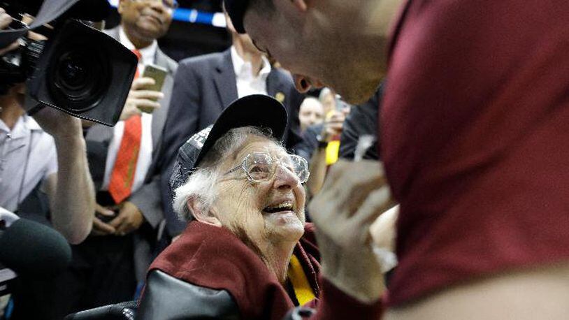 Loyola-Chicago basketball chaplain Sister Jean Dolores Schmidt speaks with Loyola-Chicago guard Ben Richardson after a regional final NCAA college basketball tournament game between Loyola-Chicago and Kansas State, Saturday, March 24, 2018, in Atlanta. Loyola-Chicago won 78-62. (AP Photo/David Goldman)