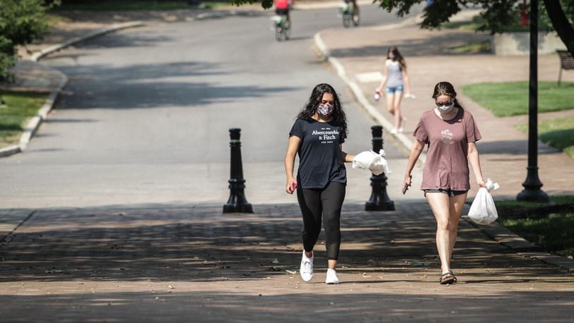 Ayesha Sheikh, left and Brooke Baker, both sophomores at the University of Dayton, walk to class with few other students during the COVID-19 outbreak Wednesday August 26, 2020. Jim Noelker/Staff