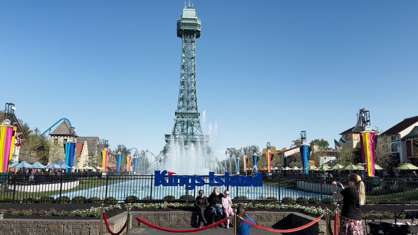 A family pauses for a photo in front of the Eiffel Tower at Kings Island on Saturday, April 20, 2024, which was the park's first open day for the 2024 season. CONTRIBUTED/KINGS ISLAND