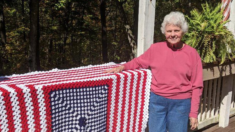 Breast cancer survivor Janet "Jan" Clements of Springdale with one of the afghans she made for the veterans. CONTRIBUTED
