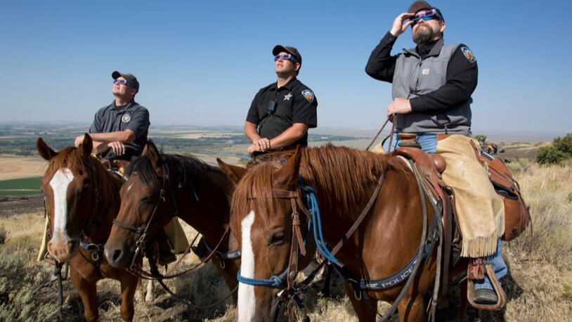 The Madison County Sheriff's Mounted Patrol  in Idaho watched the eclipse atop horses .