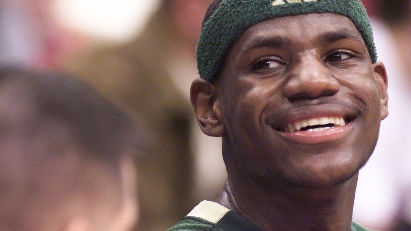 LeBron James smiles to the crowd as he sits on the St.Vincent-St.Mary bench with a minute left in the game. James scored 32 points against Poland Seminary in the Division II semifinal basketball game in March, 2002. DDN FILE