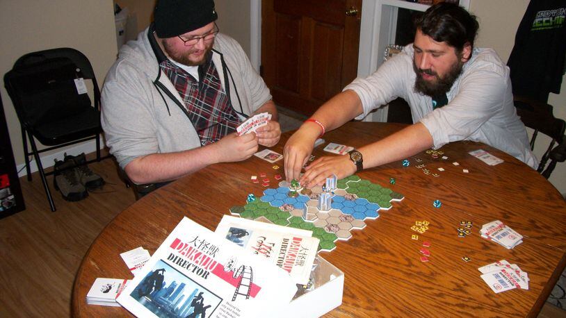 Ohio Gaming Brigade members playing Daikaiju Director, a game that will be playtested at Dayton Designed on Oct. 22. CONTRIBUTED PHOTO