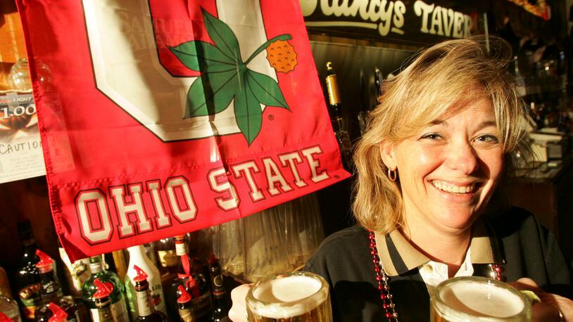 Dee Cronkhite, manager of Clancy's Tavern at 5514 Burkhardt Road, serves beer during Ohio State football games. STAFF FILE