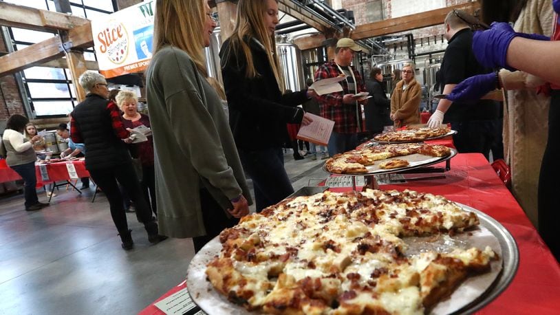 The third annual Slice of Springfield fundraiser will be held on Thursday at Mother Stewart's Brewery. Last year, hundreds of people showed up for the event to sample pizza from area pizza shops and vote for their favorite while raising money for a great cause. BILL LACKEY/STAFF