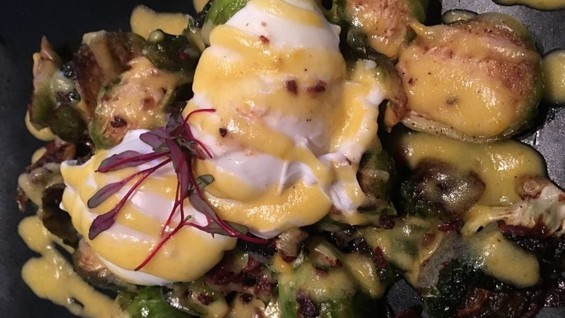 Roasted brussel sprouts ($9), topped with crispy pieces of bacon, drizzles of Hollandaise sauce and poached eggs. Contributed photo by Alexis Larsen