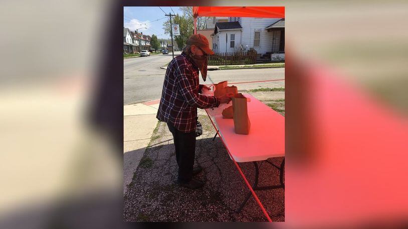 A volunteer with the Dayton-based non-profit, Food for the Journey Project, organizes bagged meals to be handed out amid the COVID-19 pandemic. CONTRIBUTED