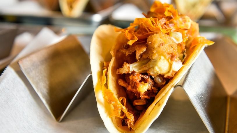 This is The Bang Bang taco with crispy cauliflower, corn fritters, queso and spicy crispy carrots. NICK GRAHAM/STAFF