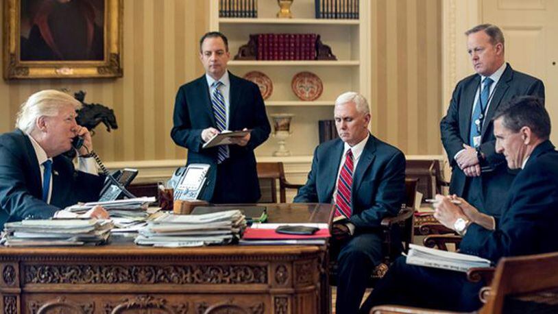 In this Jan. 28, 2017, file photo, President Donald Trump's inner circle during the early days of his presidency, from second from left, Chief of Staff Reince Priebus, Vice President Mike Pence, White House press secretary Sean Spicer and National Security Adviser Michael Flynn speaks on the phone with Russian President Vladimir Putin in the Oval Office at the White House in Washington. Flynn resigned as President Donald Trump's national security adviser Monday, Feb. 13, 2017.
