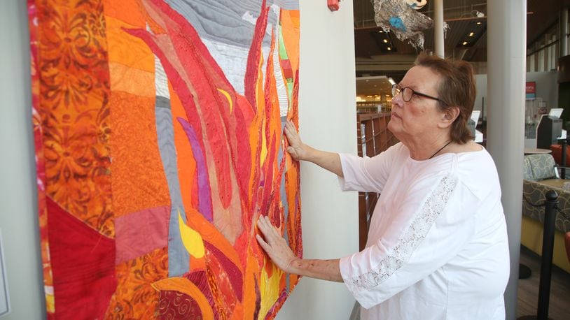 Cathy Jeffers, a Centerville fiber artist, has organized an art exhibition, The Climate Awareness Project, at the Woodbourne Library in Centerille. Dayton-area artists have created their interpretations of environmental concerns for the planet. LISA POWELL / STAFF