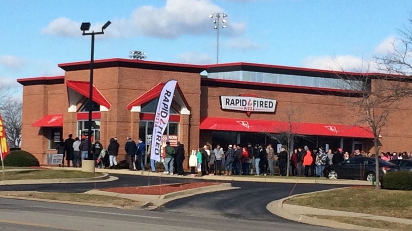 Hungry customers line up outside Rapid Fired Pizza in Kettering on Friday, Dec. 30, 2016, for the restaurant's free pizza promotion. The promotion will run through 8 p.m. or as supplies last. JEREMY KELLEY/STAFF