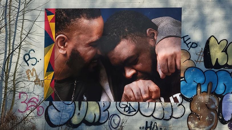 Brothers Tony and Cal Smith now have a photo of themselves embraced in a hug on a building located at Germantown Street and Dennison Avenue in Dayton. CONTRIBUTED