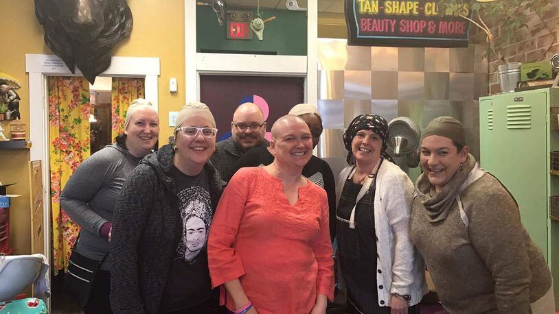 Friends wore bald head caps from Foy’s costume store during Kristen Wicker’s head-shaving shindig at Derailed Hair Salon in the Oregon District. Pictured left to right: Katie Wedell, Alexis Larsen, Anthony Shoemaker, Kristen Wicker, Amelia Robinson, Mindy Finch, Amy Forsthoefel. CONTRIBUTED