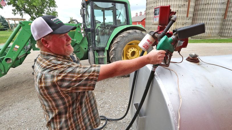 Brian Harbage fuels up one of his tractors Thursday, June 9, 2022 on his farm near South Charleston. BILL LACKEY/STAFF