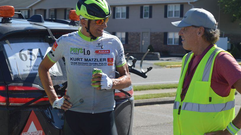 Austrian Kurt Matzler (left) not only enjoyed a cold drink and talked over strategy with support team members but he ducked into one of their vans and took a short power nap before heading back out on the course of the Race Across America June 23. BOB RATTERMAN/CONTRIBUTED