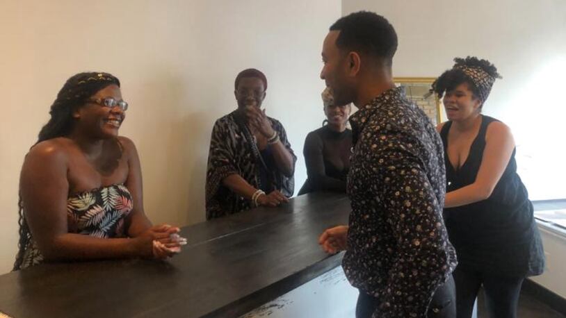 John Legend makes a stop at Puff Apothecary in the Oregon District on Sunday, Aug. 11, one week after the mass shooting that killed nine people and injured 27 others. AMELIA ROBINSON/STAFF
