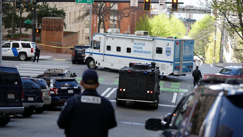 A Seattle Police vehicle turns near the scene of a shooting involving several police officers in downtown Seattle, Thursday, April 20, 2017. (AP Photo/Ted S. Warren)