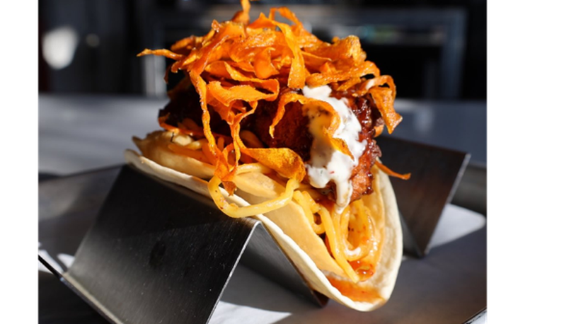 Agave & Rye, a Tequila and Bourbon Hall with two locations in the Dayton area, is introducing a fall menu with brand new EPIC Tacos. Pictured is The Skywalker Taco featuring Kung Pao Fried Chicken, Lo Mein Mix, Agave BBQ, Creamy Ranch and Spicy Crispy Carrots inside Puffy & Soft Flour Tortillas (CONTRIBUTED PHOTO).