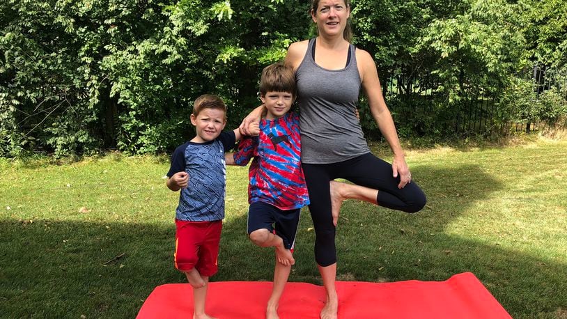 Elissa Dinsmore with her sons, Owen, 8 (left) and Johnny, 11. the family has been practicing yoga together for several years and the boys have helped their mom refine her kids yoga classes. CONTRIBUTED