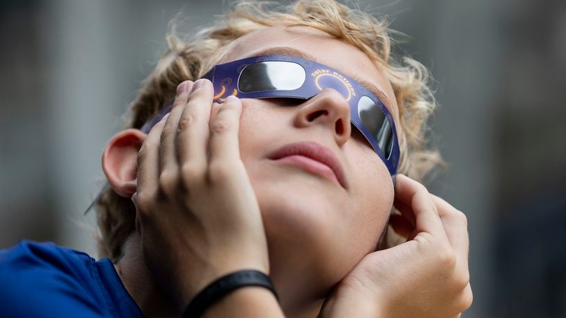 Gianluca Mazzuca, 12, watches a partial solar eclipse at the Frost Science Museum on Saturday, Oct. 14, 2023, in downtown Miami. (Matias J. Ocner/Miami Herald via AP)
