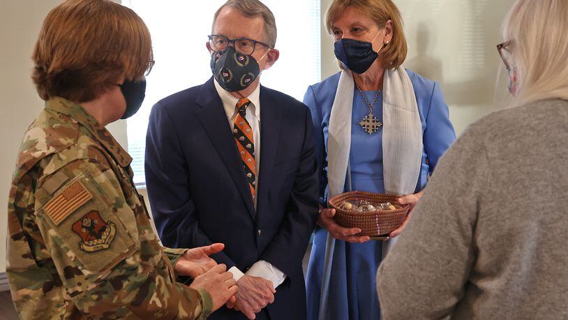 Governor Mike DeWine and his wife, Fran, visit with a woman who just got her COVID vaccinaton and a member of the National Guard assisting at the COVID vaccination clinic at New Carlisle Senior Living Friday, April 2, 2021.  BILL LACKEY/STAFF