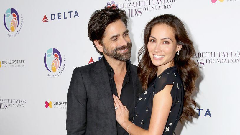 John Stamos (L) and Caitlin McHugh attend The Elizabeth Taylor AIDS Foundation and mothers2mothers dinner at Ron Burkle's Green Acres Estate on October 24, 2017 in Beverly Hills, California.  (Photo by Rachel Murray/Getty Images for mothers2mothers and The Elizabeth Taylor AIDS Foundation )
