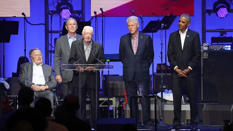 From left, former Presidents George H.W. Bush, George W. Bush, Jimmy Carter, Bill Clinton and Barack Obama address the audience during the "Deep From The Heart: One America Appeal Concert" at Texas A&M University on Saturday.