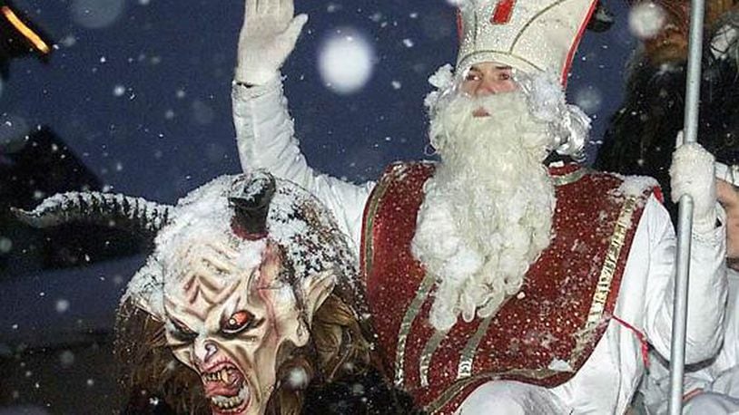 ** FILE ** Saint Nicholas, right, and his companion Krampus participate in a parade on in this Saturday, Nov. 24, 2001 file photo, in St. Johann in the Austrian province of Tyrol. Opposition to visits by St. Nick to Vienna's kindergartens by City Hall officials is creating an uproar in Austria. (AP Photo/Kerstin Joensson, file)