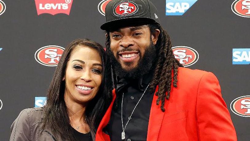 San Francisco 49ers new cornerback Richard Sherman, right, poses for a photo with his fiancÃ©e Ashley Moss after answering questions during an NFL football news conference in Santa Clara, Calif., Tuesday, March 20, 2018. Sherman agreed to a three-year deal with the 49ers. (AP Photo/Tony Avelar)